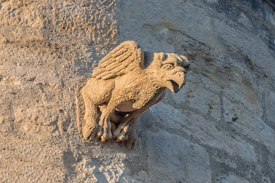 middle age bird gargoyle on a top of an ancient castle tower