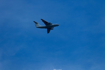 Fototapeta na wymiar Blue sky with clouds and flying airplane