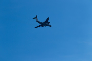 Blue sky with clouds and flying airplane