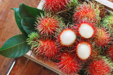 Top view of fresh rambutan in the wooden box, asian fruit, asian fruit.