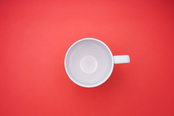 White coffee cup on red background