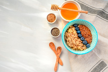 Buckwheat porridge in a bowl with flax seeds and blueberries. oncept healthy food, detox, diet, breakfast