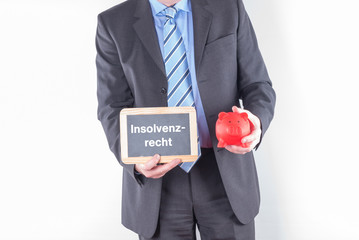 Anwalt mit einer Tafel Insolvenz Recht und einer Sparbüchse