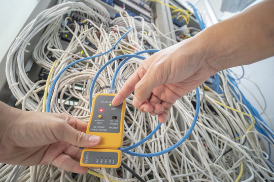 Technician is checking netwoek wires in data center
