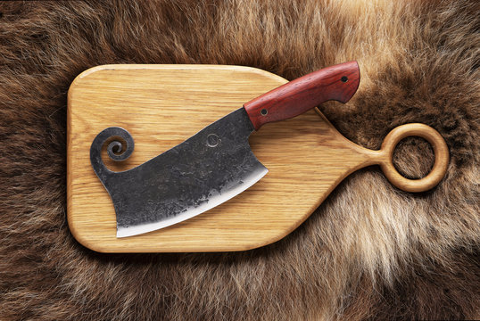 Hatchet on bear skin. Metal axe  on a bear hide.