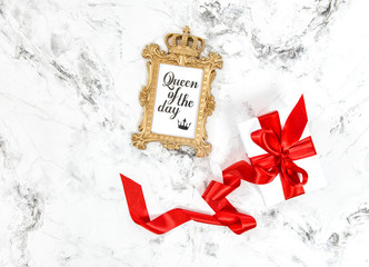 Golden frame gift box red ribbon bow Flat lay social media