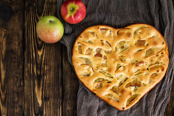 apple pies and ingredients on wooden background. Top view.