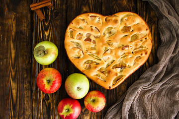 apple pie and ingredients on wooden background. Top view.