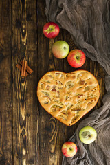 apple pie and ingredients on wooden background. Top view.