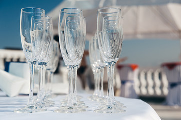 many empty wineglasses in rows at white table. welcome drink. catering