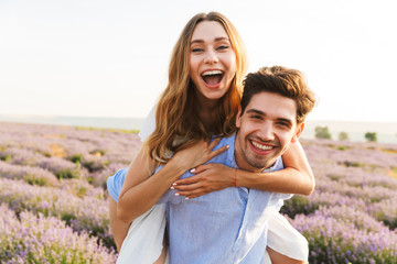 Cheery young couple having fun at the lavender