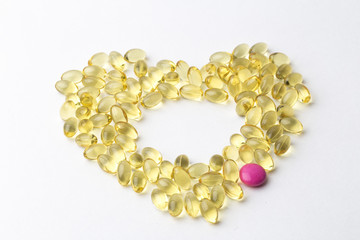 Vitamin D gel capsules. Vitamin D bottle with spilled contents isolated