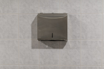 Metal toilet paper holder on the wall