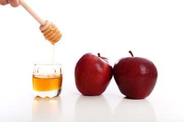 honey jar with red apple white background studio