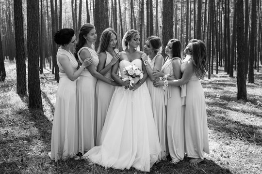 Black and white wedding photo. Bride and bridesmaids having fun at wedding day. Happy marriage and wedding party concept