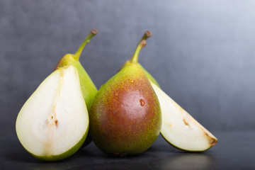 Qtee pears on a grey background