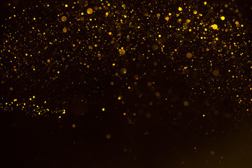 Glitter gold sparkling star dust falling shiny abstract bokeh background - 219762502