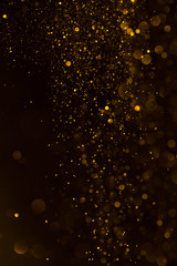 Glitter golden sparkling dust falling shiny abstract bokeh background