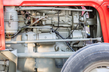 Detail of tractor machine or engine. Whit visible fuel pump, engine starter, oil filter and...