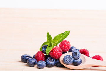 Fresh sweet blueberry fruit and leaf of mint.
