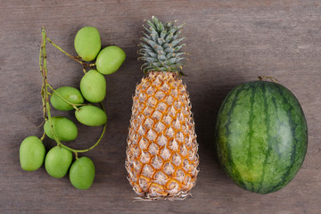 Nice tropical fruits on wooden table, Top view