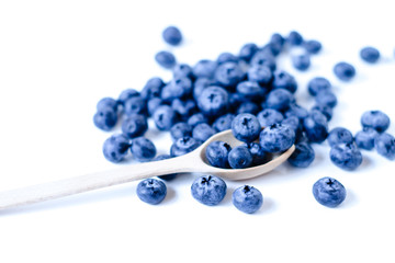 Fresh sweet blueberry fruit in spoon. Shallow depth of field