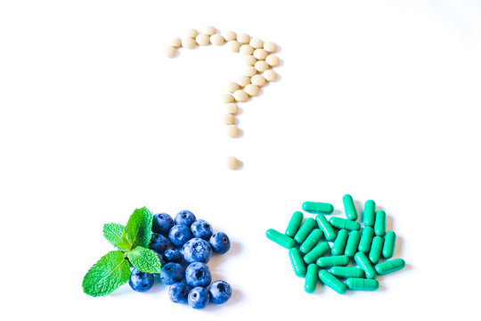 Fresh sweet blueberry fruit and leaf of mint with pills or capsules