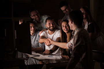 business colleagues shaking hands at the Desk