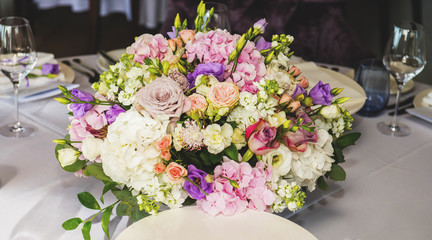 Table layout at restaurant with a bouquet of flowers
