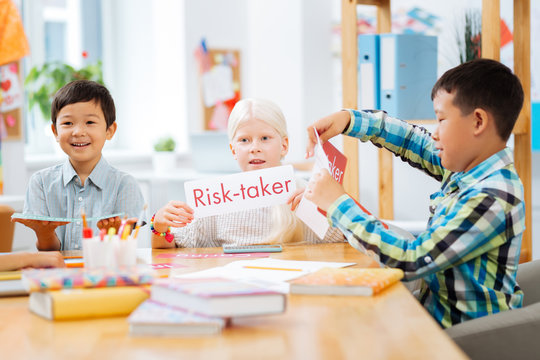 Fantasy. Smart clever children creating interesting games while sitting in a classroom