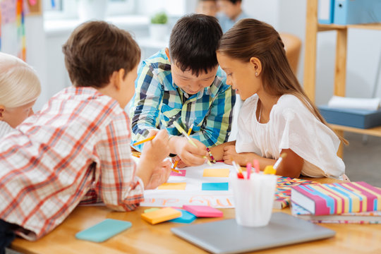 Talanted. Creative kids drawing while being in a classroom - Powered by Adobe