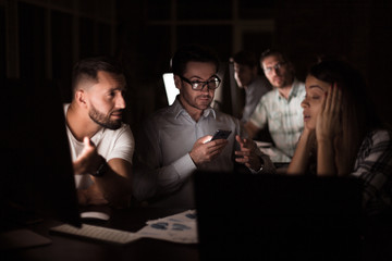 boss looks at the screen of his smartphone
