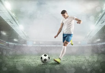 Kussenhoes Soccer player on a football field in dynamic action at summer day © Andrii IURLOV