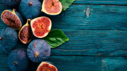 Fig. Fresh fruit figs on a blue wooden table. Free space for text. Top view.