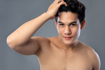 Fototapeta na wymiar Shirtless young hamdsome Asian man with clean radiant face