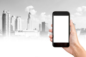 Hand holding smartphone with  city buildings in background