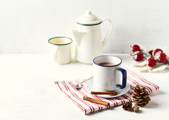 Mug of hot milk with cocoa and cinnamon for Christmas. Winter still life