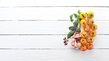 Food Background. Cherry tomatoes, spices and sauces. Top view. On a wooden background. Free space for text.
