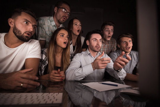 surprised business team looking at the computer monitor