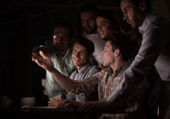 business team looks closely at the computer monitor