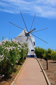 Whitewashed traditional windmill at the top of the hill by the St Anthonys chapel, Castro Marim, Algarve, Portugal.