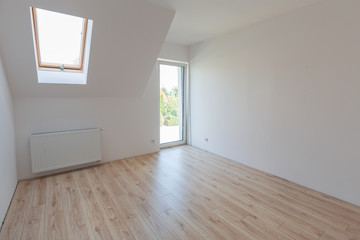 Fototapeta na wymiar Bedroom with new laminated floors in the house