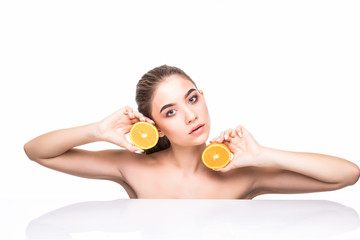 Obraz na płótnie Canvas Young woman with orange in her hands isolated on white background. Skin care concept.