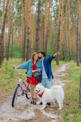 Fototapeta premium Bike together. Bearded husband feeling happy while kissing his woman riding bike in the forest together