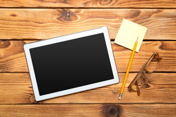 White digital tablet on wooden table