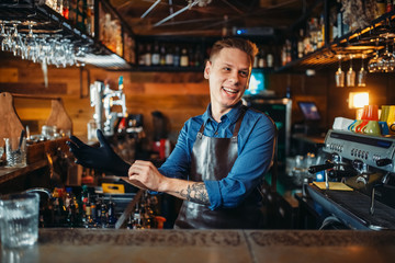 Bartender puts on rubber gloves at the bar counter