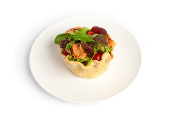  Salad with red fish, tomatoes and greens in a bread basket