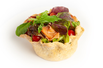  Salad with red fish, tomatoes and greens in a bread basket