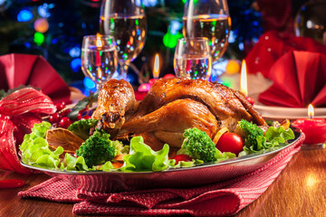 Fototapeta na wymiar Baked or roasted whole chicken on Christmas table