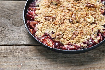 Oatmeal crumble with fresh berries and walnuts. Gluten free summer berries crisp. Selective focus